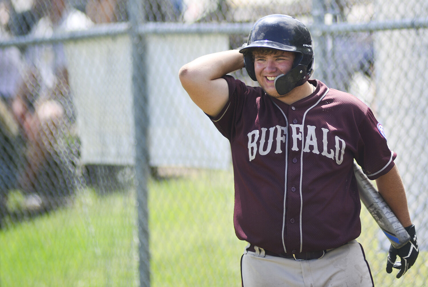 Matt Harrison laughs while talking to his coach before the start of the inning
